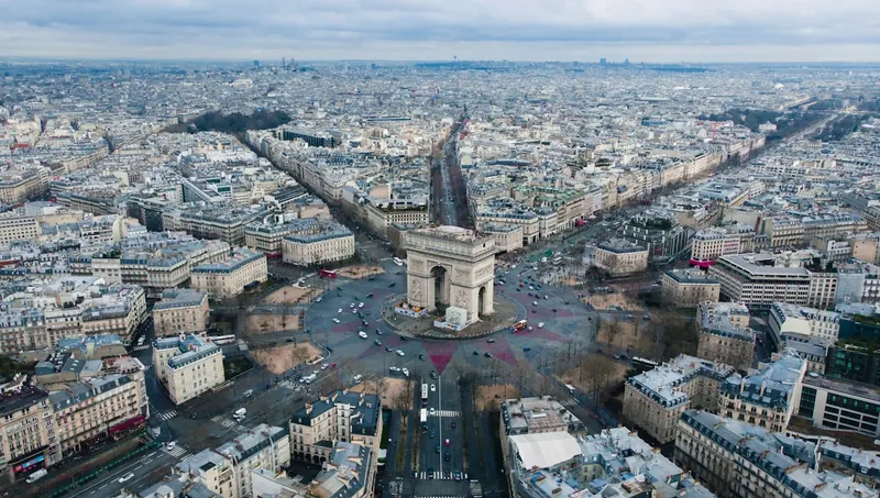 A Paris Métro train arriving on an elevated line near the Eiffel Tower